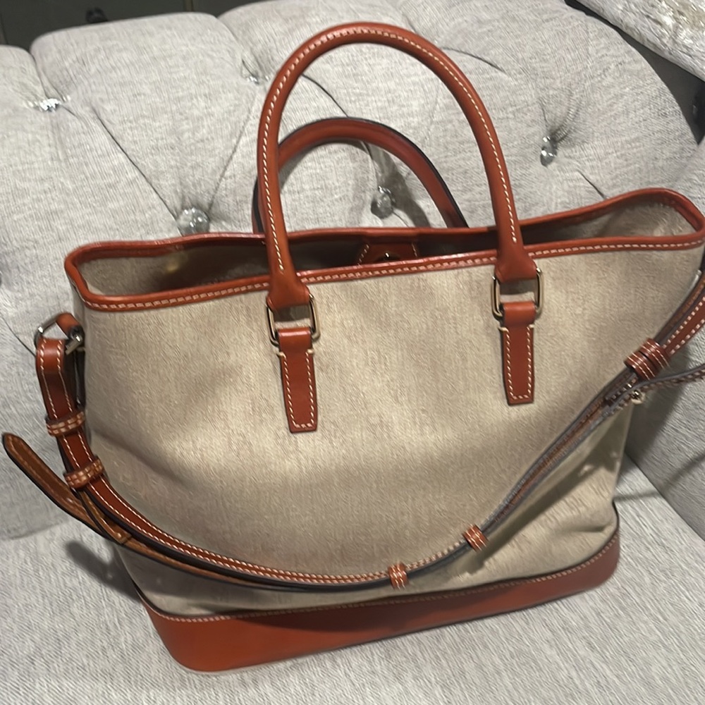 Like New Dooney & Bourke two ways handbag beige and cognac leather triming.